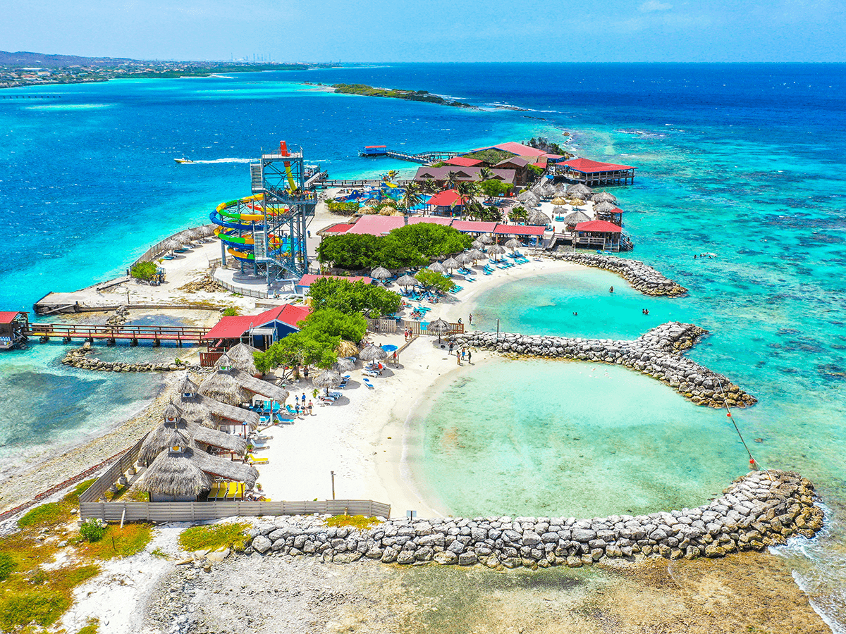 a group of people on a beach near a body of water