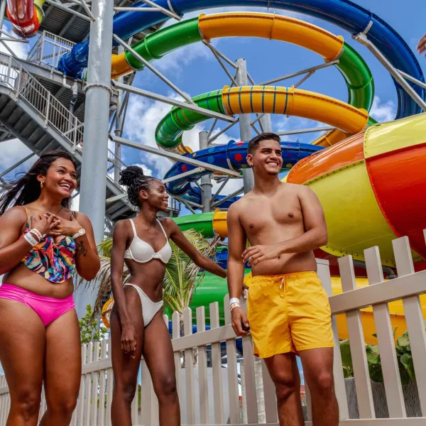 a group of people on a beach posing for the camera