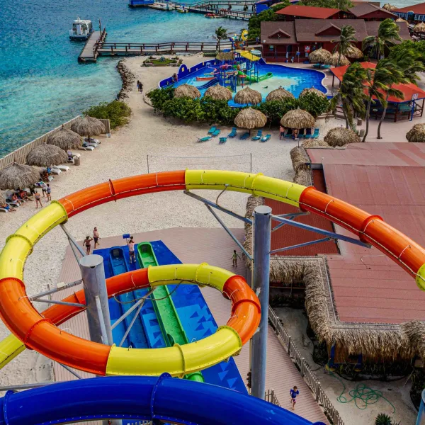 a group of people on a beach near a body of water