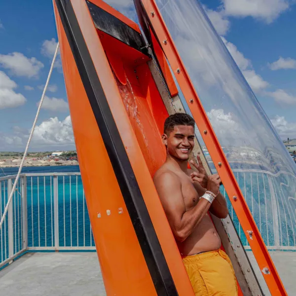 a man standing next to a body of water