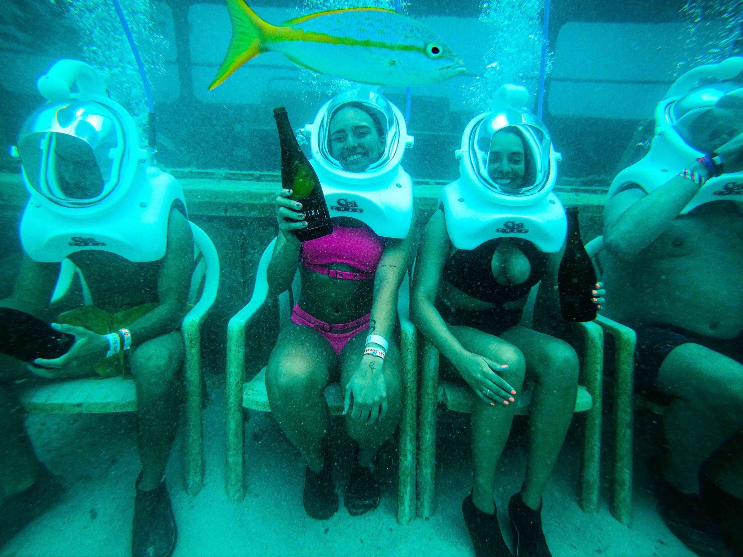 a group of men sitting in a swimming pool