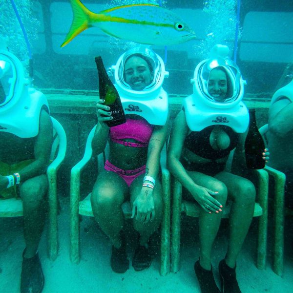 a group of men sitting in a swimming pool