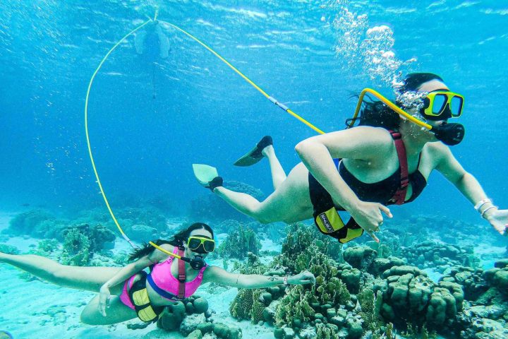 a man standing next to a body of water