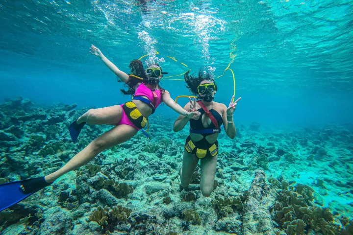 a person standing next to a body of water